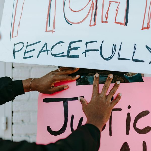 Person meditating peacefully with a serene background.